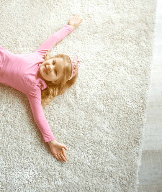 Cute girl laying on rug | Carpetland USA of Virginia