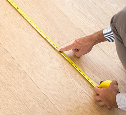 Man measuring floor | Carpetland USA of Virginia